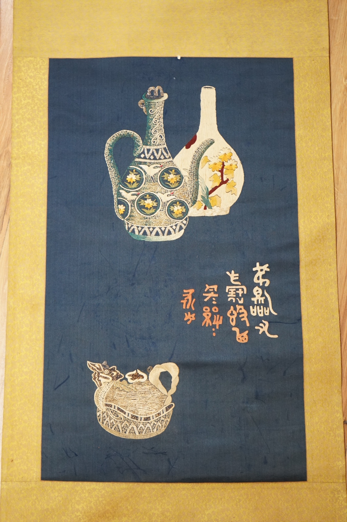 Two early 20th century Chinese embroidered silk scrolls to include one depicting flowers. Condition - fair/good